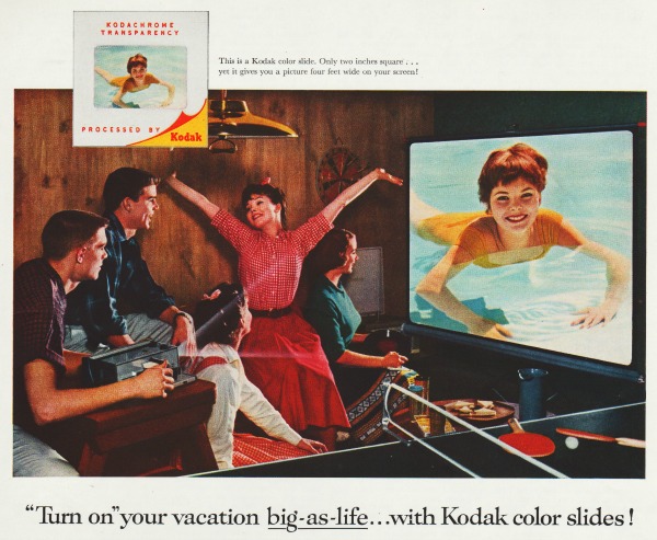 1950s family in rumpus room viewing slides 