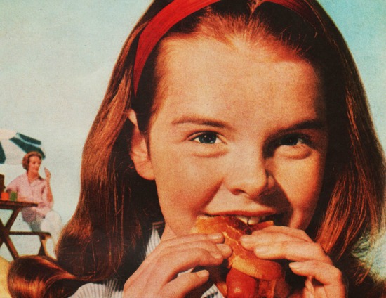 Vintage girl eating hot dog