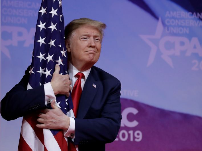 Trump hugging American flag